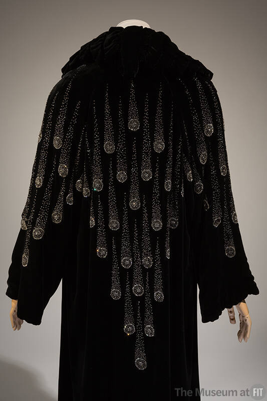 Back view of black evening coat with comet design in crystal seed beads and rhinestones