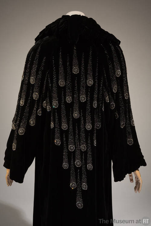 Back view of black evening coat with comet design in crystal seed beads and rhinestones