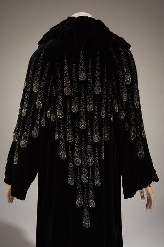Back view of black evening coat with comet design in crystal seed beads and rhinestones