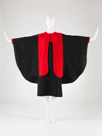 Black dress with red trim accent and matching cape