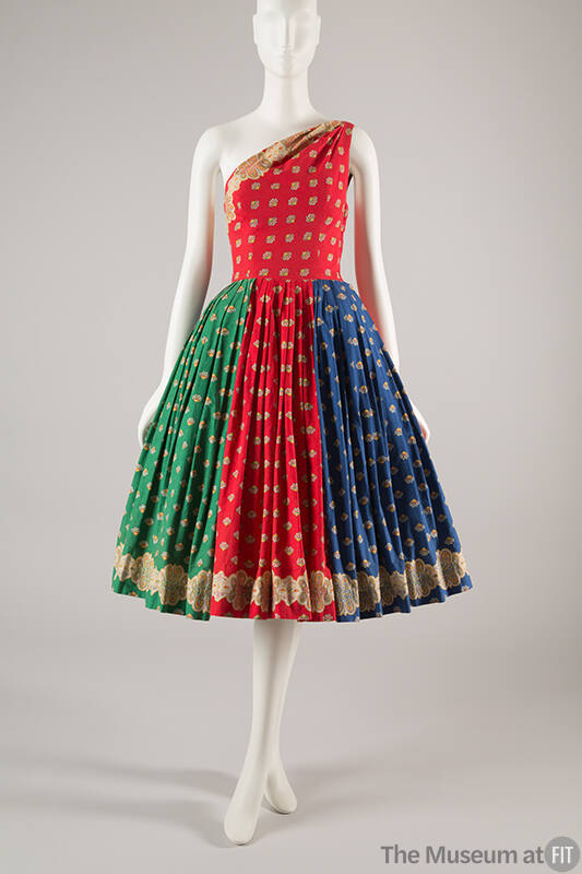 Red, green, and blue dress with spaced print in yellow, red, blue, and black; fitted one should…