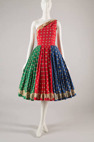 Red, green, and blue dress with spaced print in yellow, red, blue, and black; fitted one should…