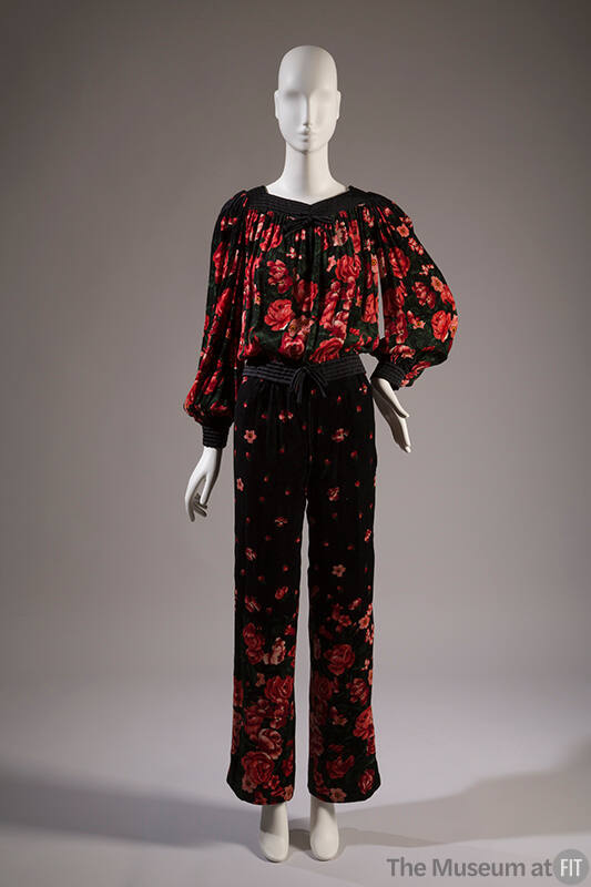 Black velour top and matching pants set in floral print of red, pink and green; long voluminous…