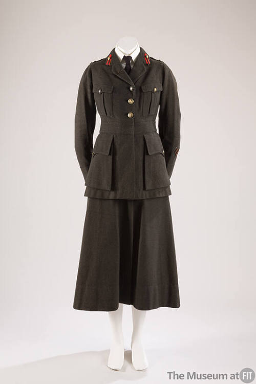 Dark grey/green military jacket with red pins on lapels, three gold buttons and patch pockets o…