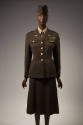 Women's Army green uniform suit, fitted jacket with large gold buttons, wings and U.S. pins on …