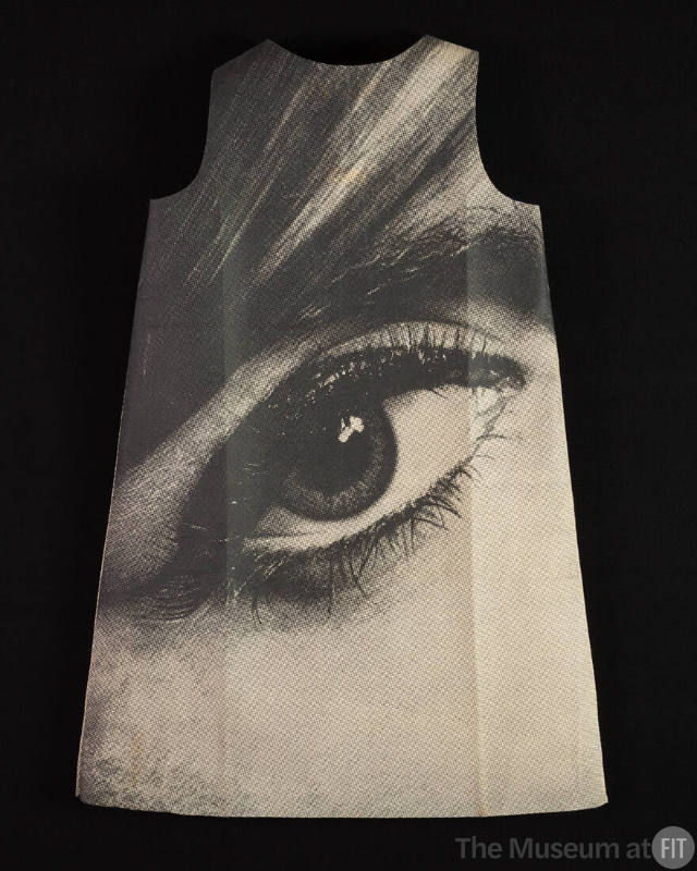 Sleeveless A-line mini dress with large black and white photo print of a human eye on black bac…