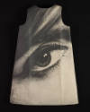 Sleeveless A-line mini dress with large black and white photo print of a human eye on black bac…