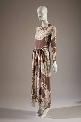 Taupe floor length shift and panel overskirt printed with white symmetrical linear drawing of c…