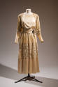 Cream above the ankle length afternoon dress with long sleeves, insets of lace at shoulders, sl…