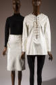 White lace-up front to-the-knee skirt with black turtleneck top and white lace-up  long sleeve …