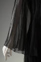 Detail of black sheer with lace cape sleeve