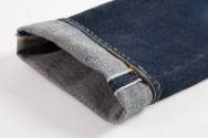 Detail of turned up jeans cuff and selvedge 