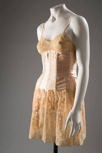 Pink satin boned corset over lace slip, thin shoulder straps, garters under skirt
