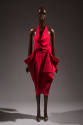 Sleeveless red dress with cowl front halter bib over strapless bodice; calf length wrap skirt w…