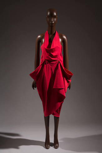 Sleeveless red dress with cowl front halter bib over strapless bodice; calf length wrap skirt w…