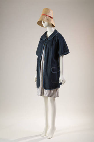 Denim short sleeve hip length jacket with flap pockets over a blue and white striped to-the-kne…