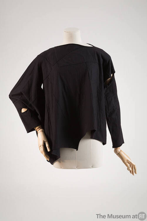 Black long sleeve patchwork top and cutouts and uneven hem