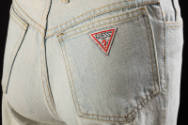 Detail of back pocket and Guess jeans triangular label 