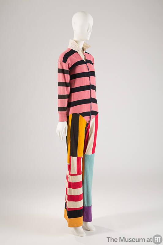 Pink, black, yellow, red, and blue long sleeve jumpsuit with patchwork striped sections