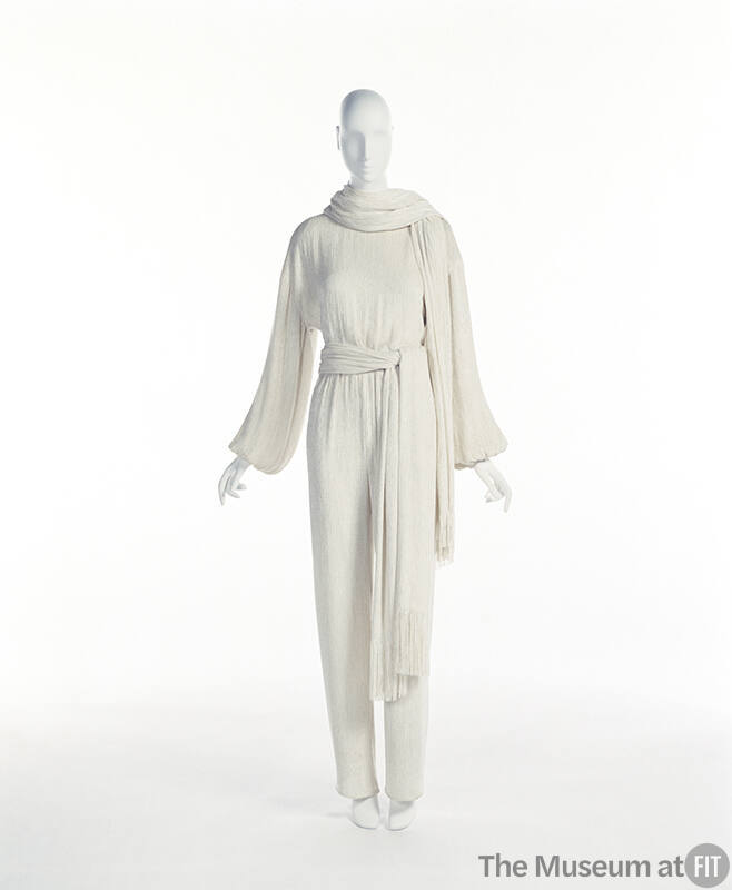 Off-white long sleeve jumpsuit with matching scarf and waist sash with fringe ends