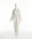 Off-white long sleeve jumpsuit with matching scarf and waist sash with fringe ends