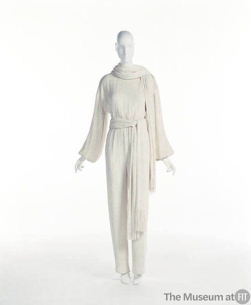 Off-white long sleeve jumpsuit with matching scarf and waist sash with fringe ends