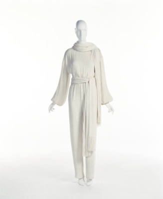 Off-white long sleeve jumpsuit with matching scarf and waist sash with fringe ends