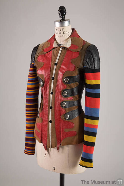 Fitted leather jacket with multicolor striped sleeves and abstract shapes of tan, red and black…