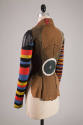 Back view of jacket showing tan circular designs, large white and navy blue concentric circles …