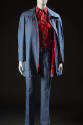 Man’s light blue denim leisure suit ensemble with red zipper on jacket and red, black and white…