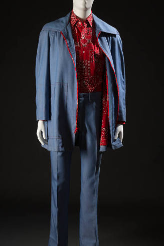 Man’s light blue denim leisure suit ensemble with red zipper on jacket and red, black and white…