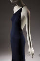 ¾ view of navy blue one shoulder evening dress with thin spaghetti strap