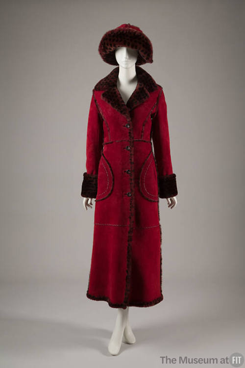 Dark red calf length coat trimmed with light red spotted fur on collar, cuffs, and on matching …