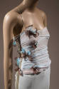 Detail view of blue evening dress bodice showing appliqued butterflies and draped fabric