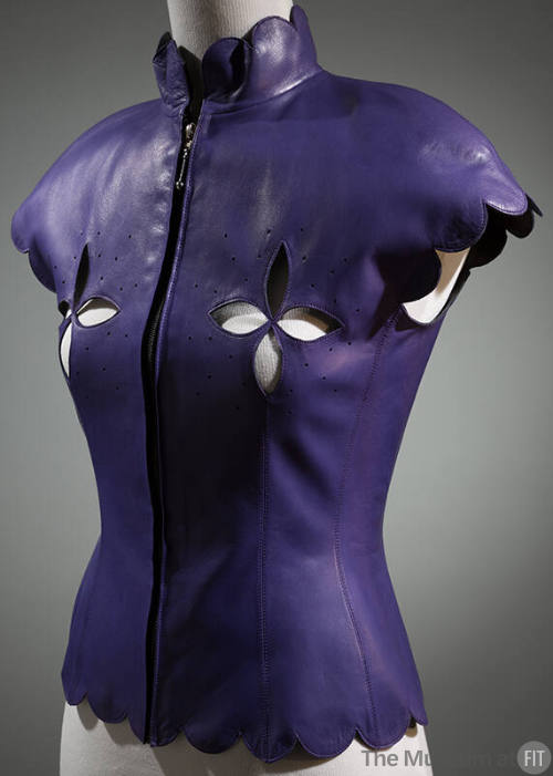 Purple leather top with scalloped stand collar, cap sleeves and hem, cut out designs at bust an…