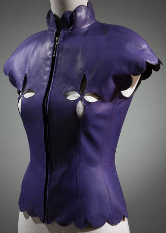 Purple leather top with scalloped stand collar, cap sleeves and hem, cut out designs at bust an…