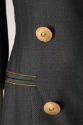 Detail of gold metal buttons on blue silk and slash pocket