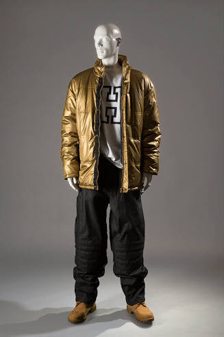 Gold puffer jacket over white t-shirt with H logo and black quilted pants 