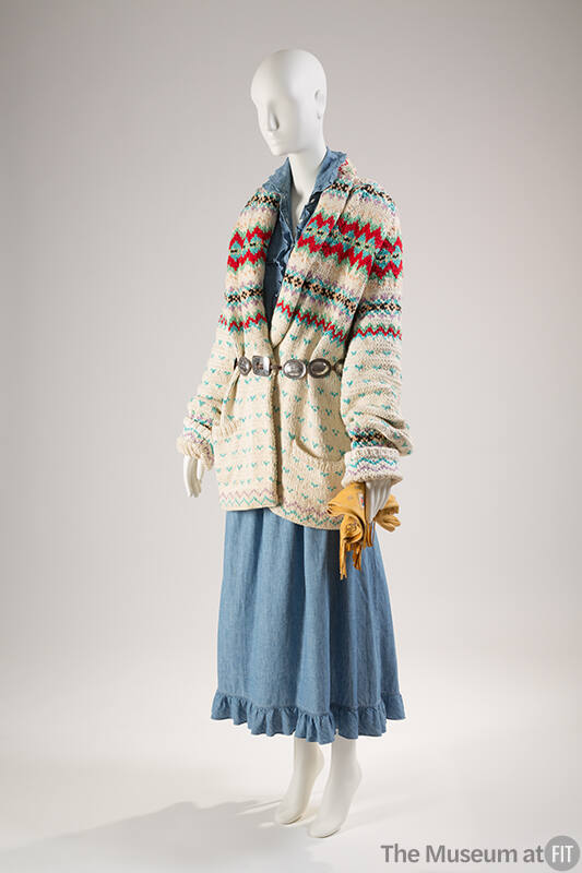 Off-white and multicolor long sleeve shawl collar sweater over blue denim dress with ruffle tri…