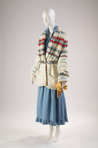 Off-white and multicolor long sleeve shawl collar sweater over blue denim dress with ruffle tri…