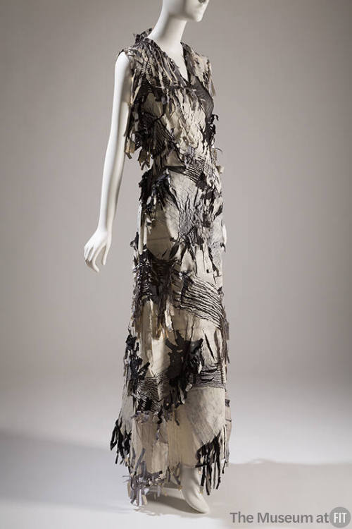Black and white sleeveless floor length dress with woven sections and fringe