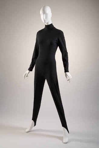 Black turtleneck catsuit with long sleeves, tapered leg with stirrup