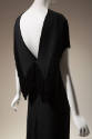 Black evening dress with plunging v-back with fringed collar