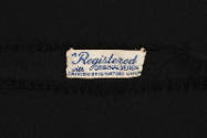 tag that reads, "Registered with original design Fashion Originators Guild"