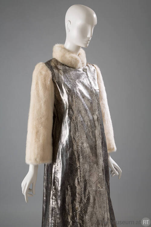 Detail of metallic silver snakeskin coat with white fur collar and long sleeves