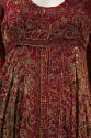 Detail of red dress fabric with gold metallic thread and sequin embroidery