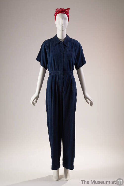 Blue denim short sleeve jumpsuit, covered placket front and breast pocket