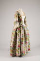 Mauve gown with large pink, green, brown and blue floral brocade, off-white stomacher and elbow…