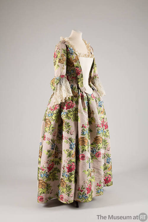 Mauve gown with large pink, green, brown and blue floral brocade, off-white stomacher and elbow…