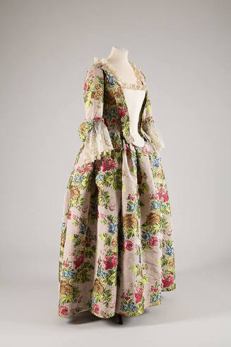 Mauve gown with large pink, green, brown and blue floral brocade, off-white stomacher and elbow…